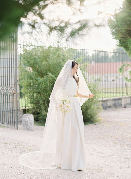 A bride wearing a chapel length lace wedding veil