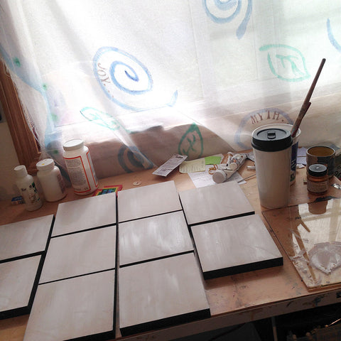 studio drawing table with canvases being prepared