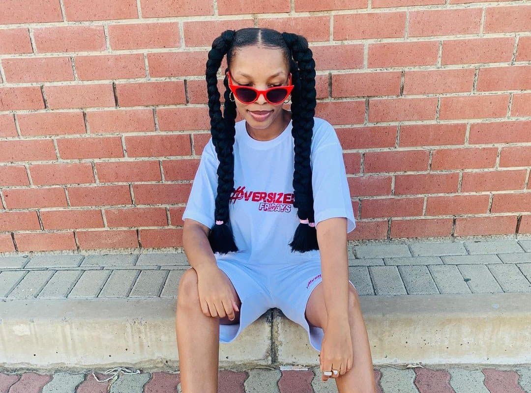 girl with black 4-jumbo braids and sunglasses
