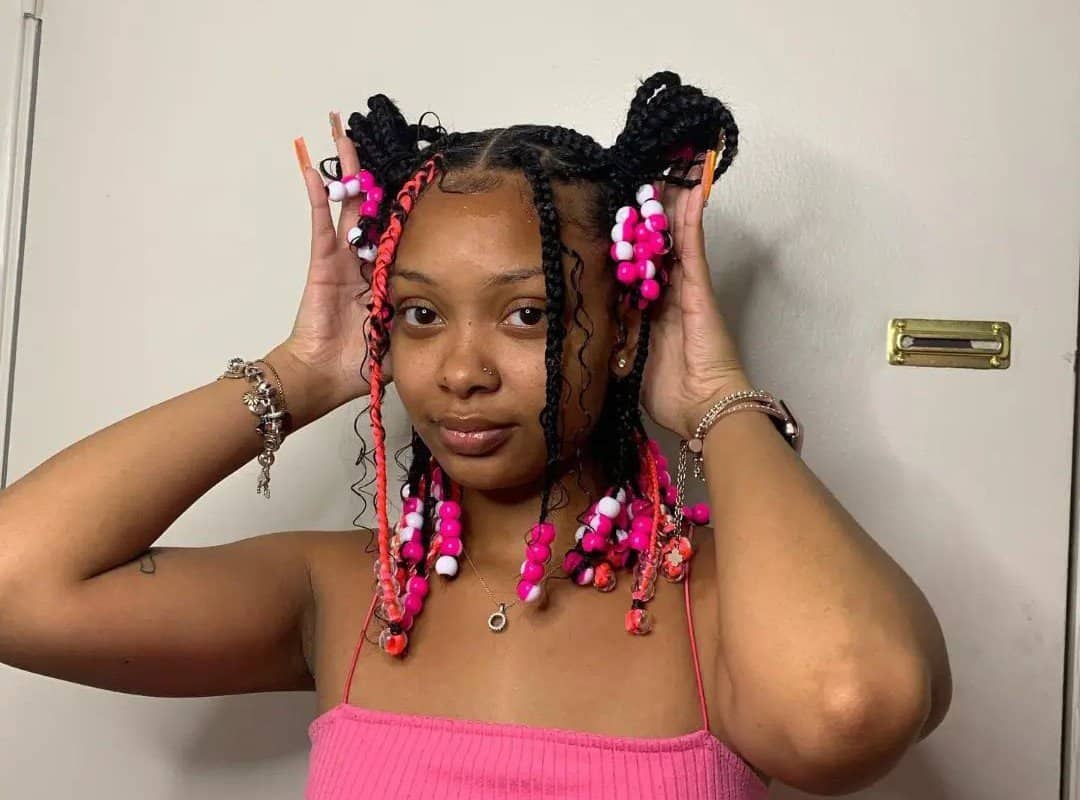 girl with black bob tribal braids with red and white beads