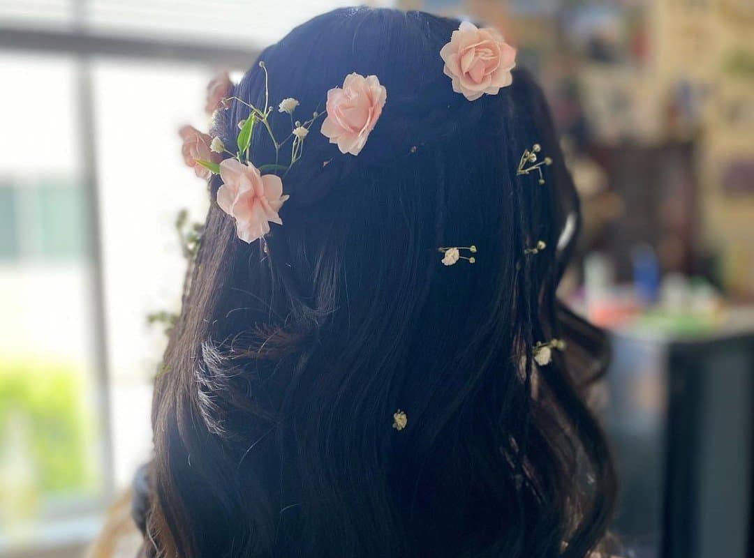 girl with black curls with flowers