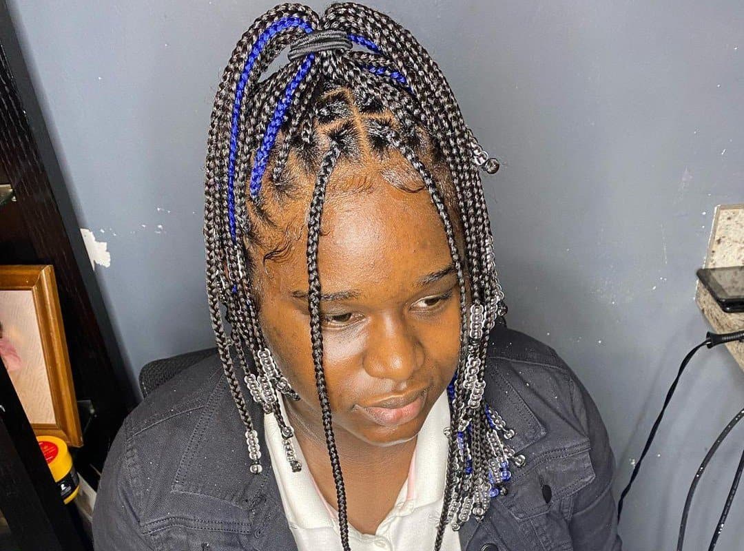 woman with black knotless braids with beads with blue added hair