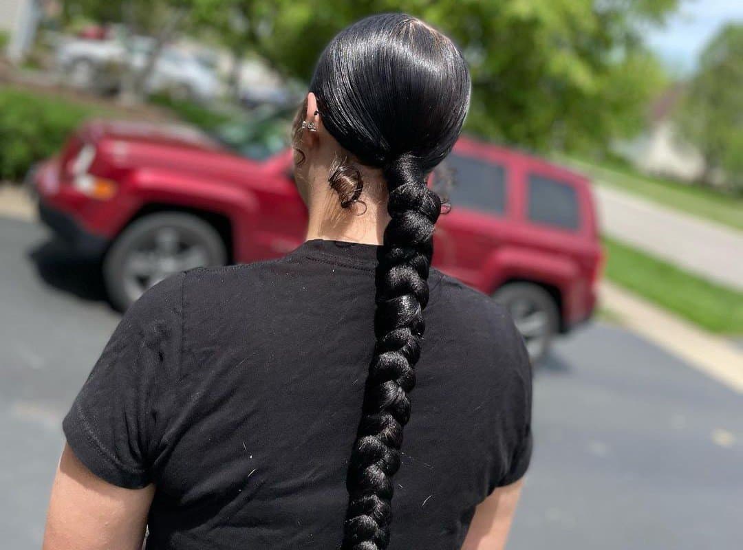 girl with black low sleek braided ponytail