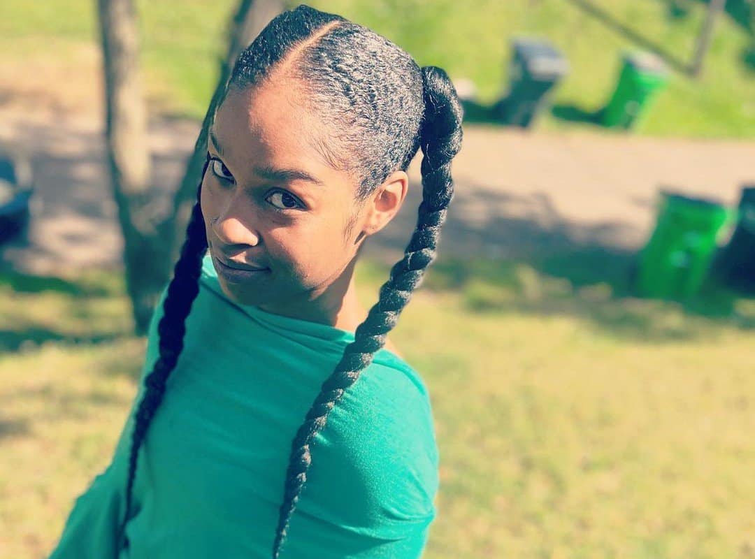 girl with black sleek braided ponytails