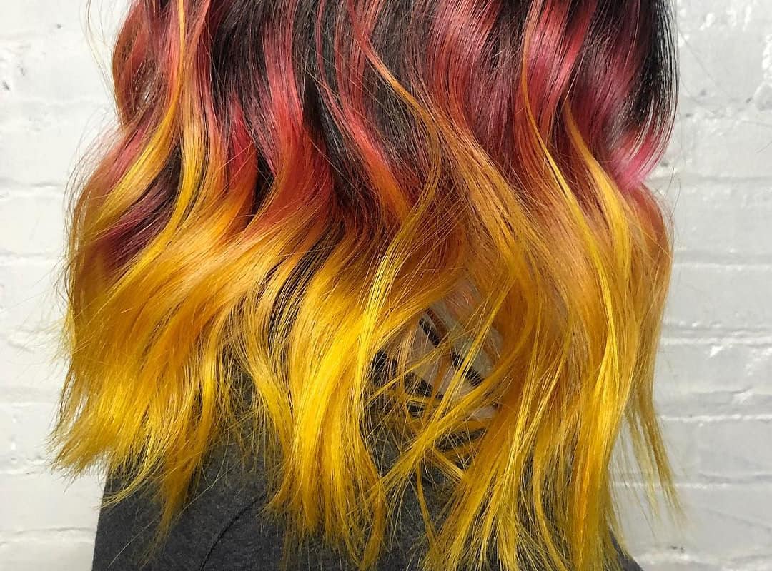 Red to yellow ombre on dark hair