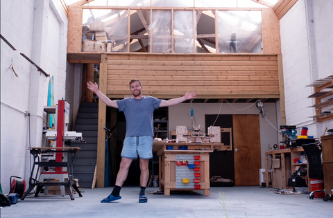 Jack standing in Mosevic's workshop in Cornwall, England