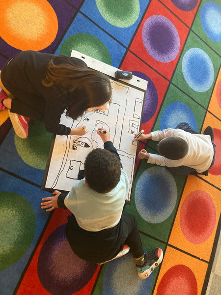 Students working together on a drawing using the Flipchart