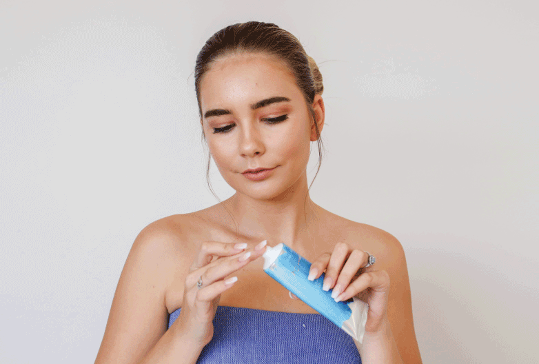 Girl applying Organic Conscious Coconut Oil as lip balm