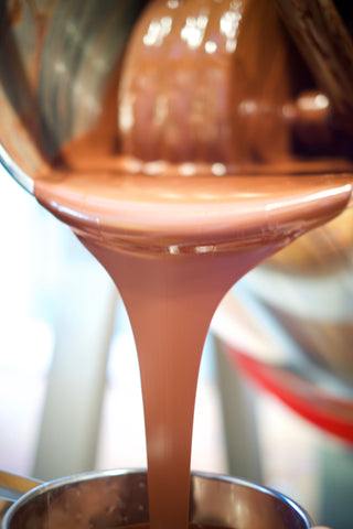 Dark chocolate pouring into blocks