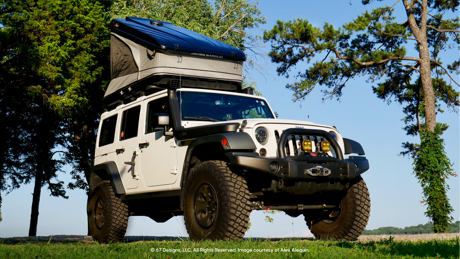 Shot of white overlanding vehicle on grass