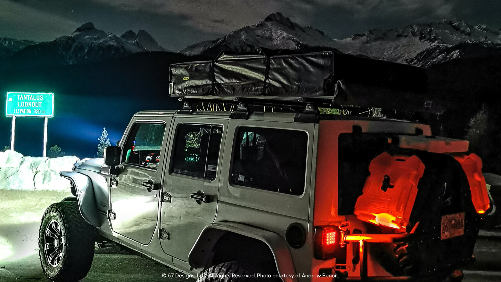 Jeep overlooking some mountains at night