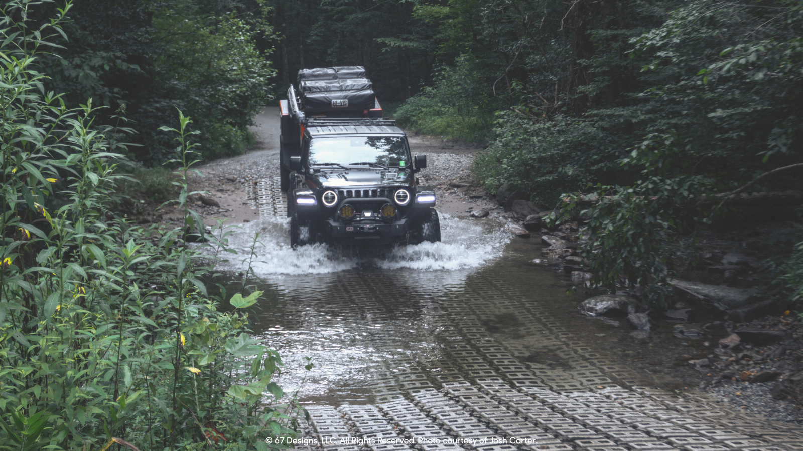 Jeep going through large puddle.