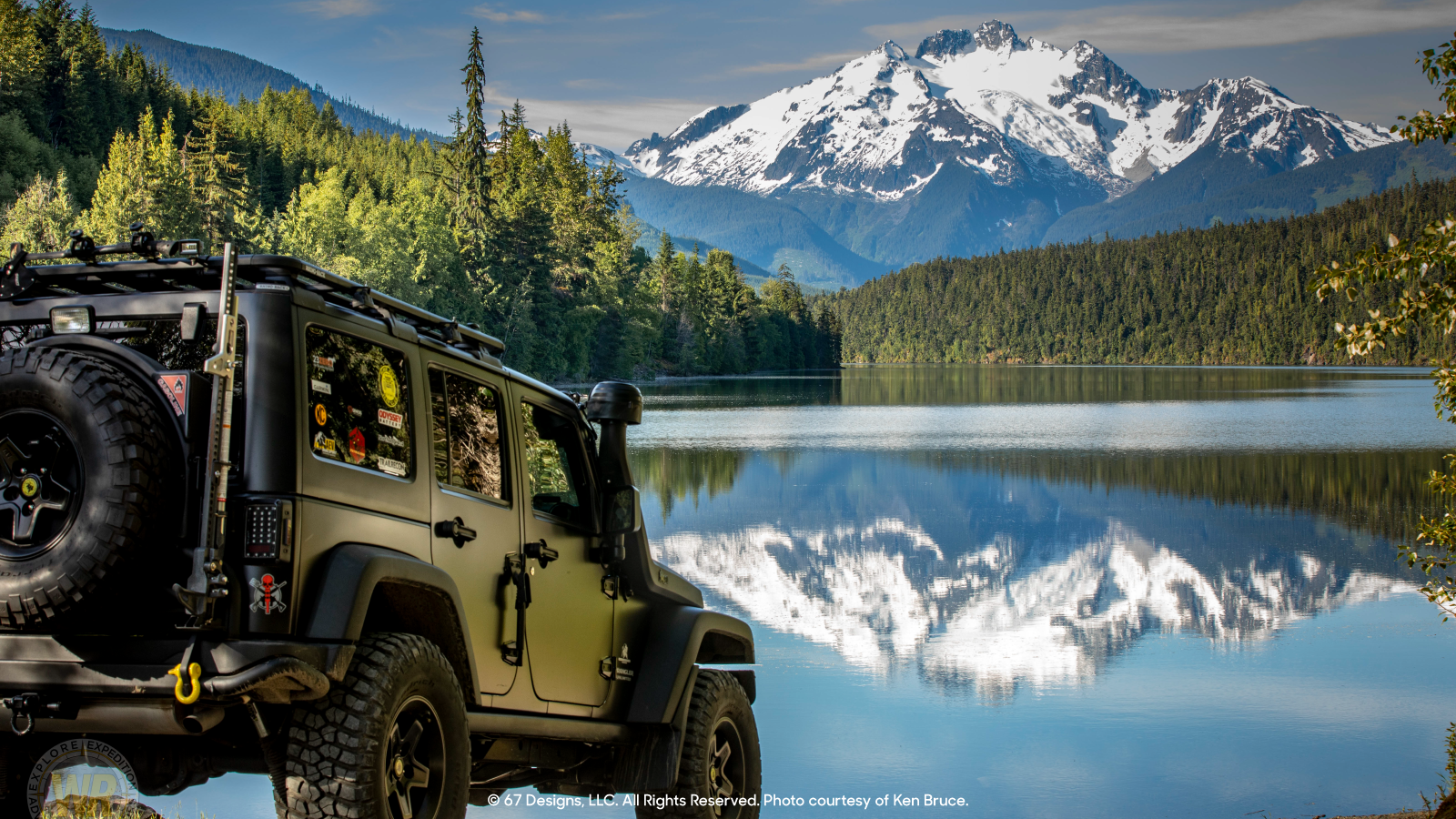 Jeep overlooking snow capped mountains