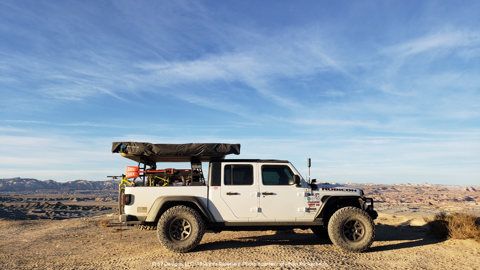 Jeep among mountainous range.