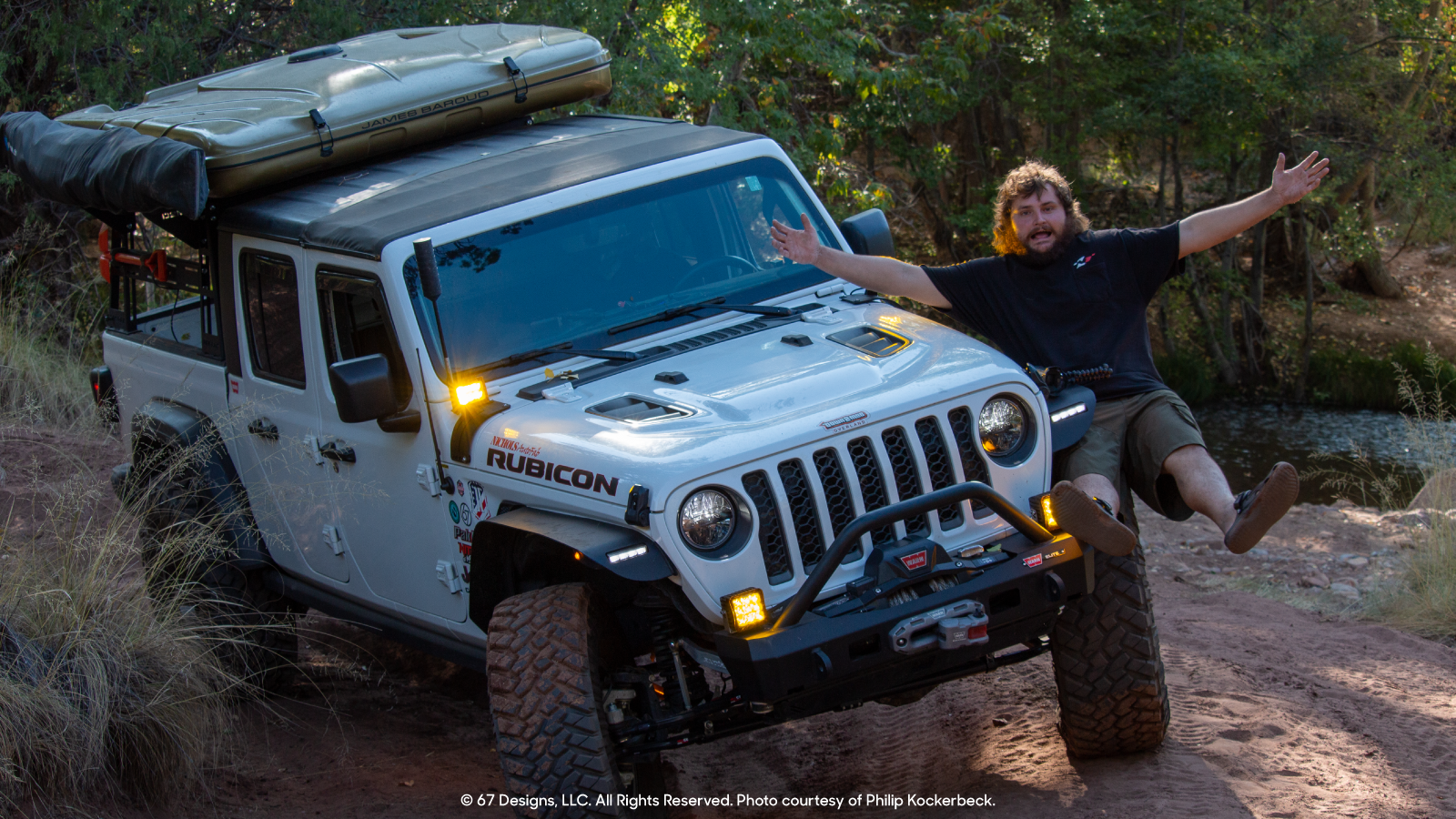 Philip hanging off his Jeep