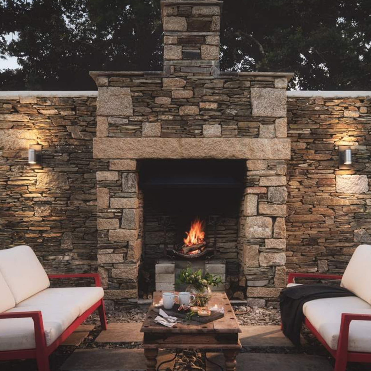 firepit outside with benches and stone surround