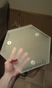 Magnetically attached acrylic build plate.  Deltamaker logo on three edges gives it a cool look.