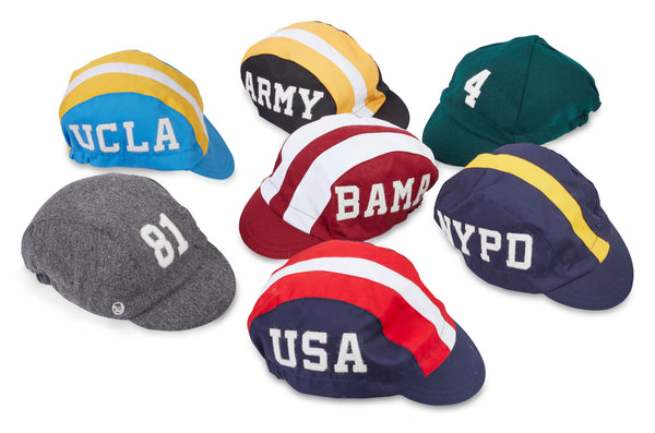 Assortment of caps with custom applique numbers and letters on the front and sides.