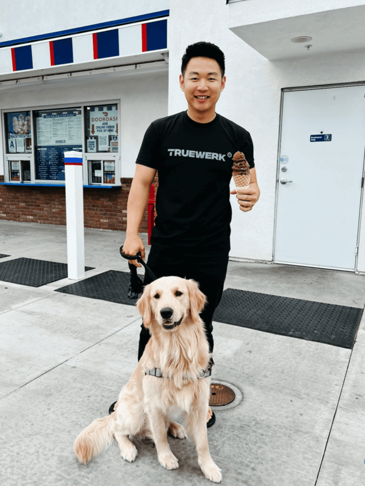 Moses Cho wears a Truewerk logo tee and poses with his dog