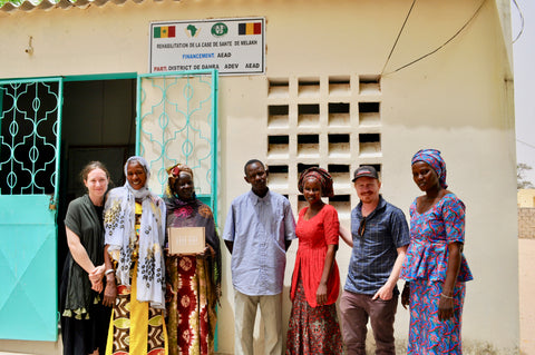 Bokk Baby co-founders Margaret Davidson and Danny White posing with Senegal locals