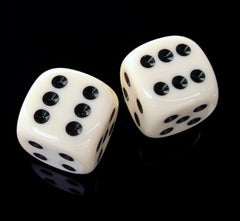 A photo of two six-sided dice on black background. The dice are white with black dots, and have the six result facing upwards. 