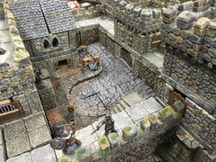 A photo of 3-dimensional terrain used for dungeons and dragons. It looks like a miniature castle, with small figures of adventurers dispersed around it. 