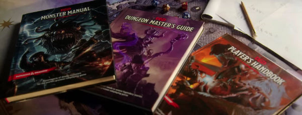 A photo of the players handbook, dungeon masters guide, and monster manual from 5e