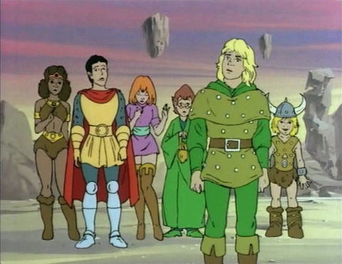 A screenshot from the DnD Cartoon. It shows several fantasy adventurers in front of a purple and pink sky, standing on sand. In the foremost front is a man with green armor and clothes and blonde hair, behind him are sevearl other people