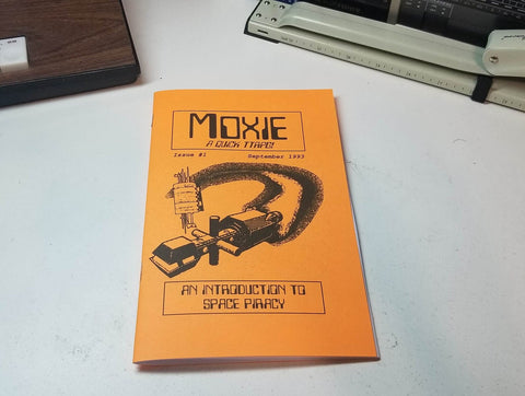A photo of the cover of Moxie against a white table. 