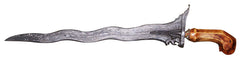 A photo of a kris, an assymetrical knife with a wavy blade