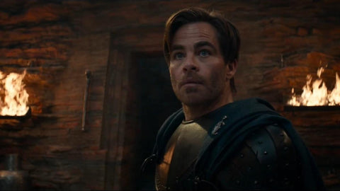 A screenshot from the Dungeons and Dragons Honor Among Thieves trailer, showing a blond man wearing armor standing in front of a stone wall