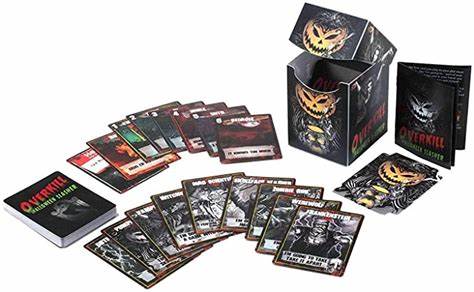 A photo of the contents of a game of Overkill. It includes several decks of cards, a rulebook, and a plastic deck box. 