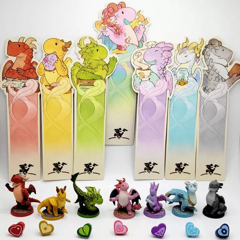 A photo of a set of bookmarks and dragon miniatures used for Flamecraft. There are dragons and bookmarks in blue, yellow, green, purple, red, grey, and white/pink