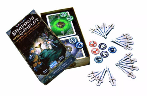 A photo of the components of Shadows Over Camelot: The Card Game. The photo shows the box, open, with several cards inside. Next to the box are punch out tokens of swords and small circular symbols
