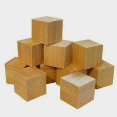 A photo of several plain wooden cubes, stacked in a small pile, against a white background