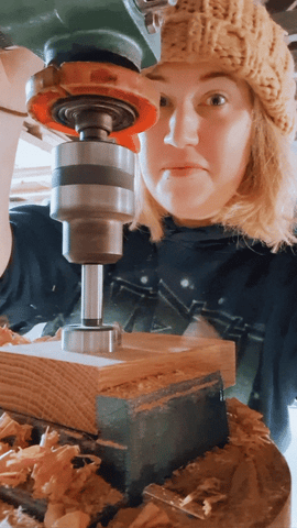 gif of Lauren from ingrained inc in the smiddy workshop using a drill press, whilst making an oak candle tealight holder.