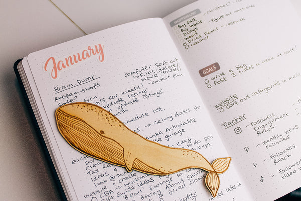 monthly bullet journal spread with a whale bookmark