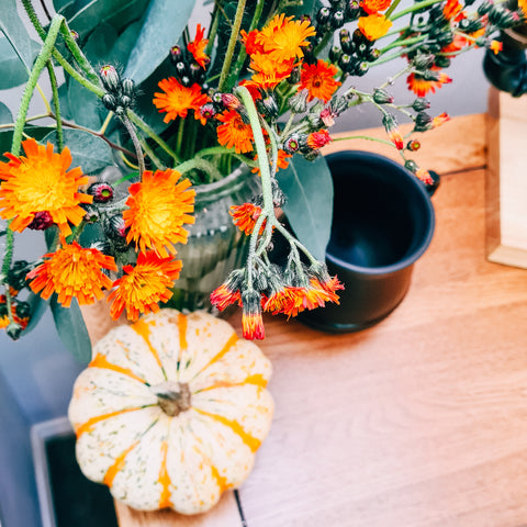 orange colour autumn decor with floral arrangement and pumpkin
