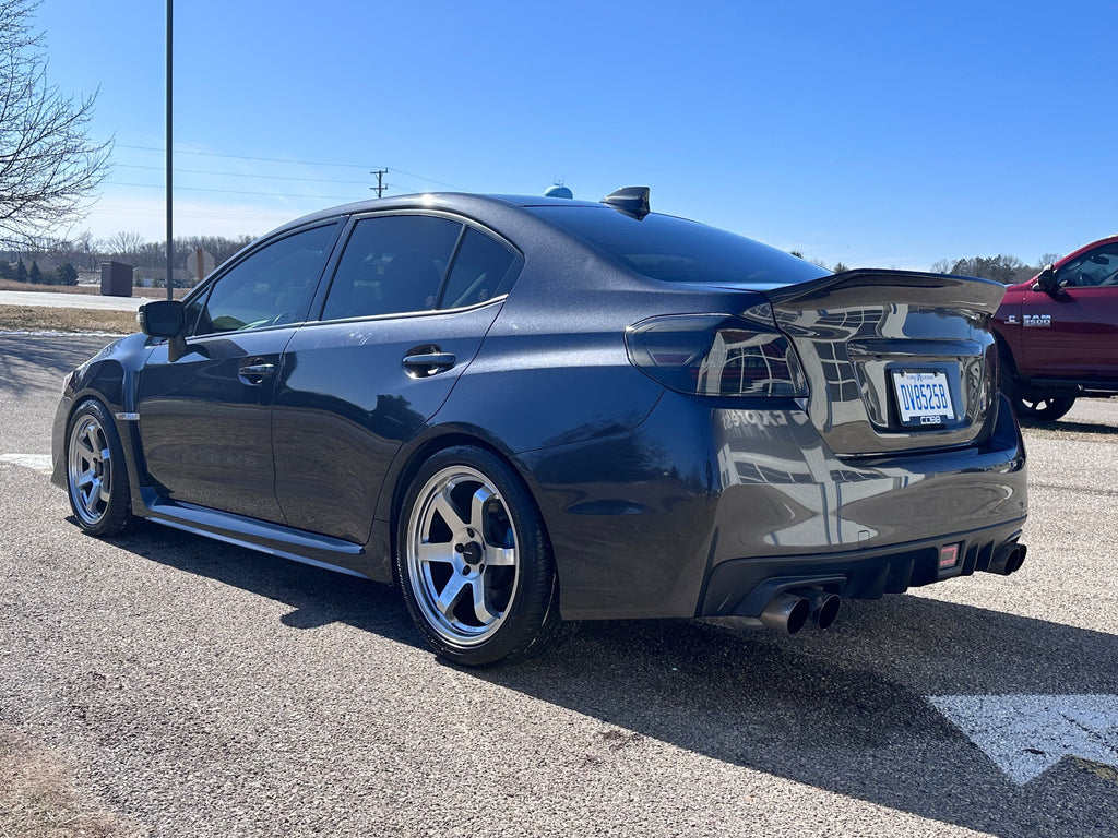 rear shot of gray car with evolved autosport coilovers