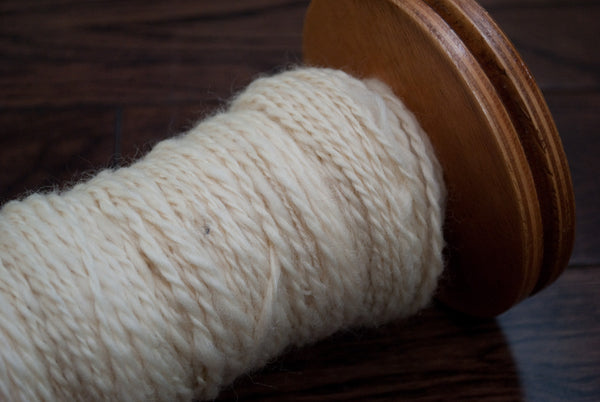 Bobbin with spun yarn