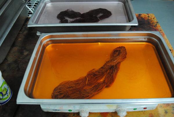 Orange yarn in dye bath