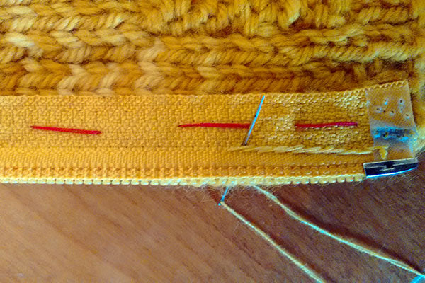 Sewing zipper in place with backstitch