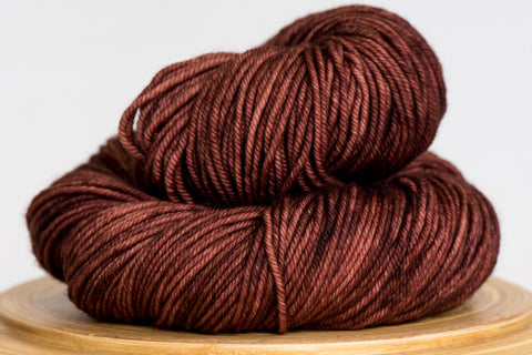 Minuet superwash merino DK hand-dyed yarn in hot cocoa, a tonal mid-brown