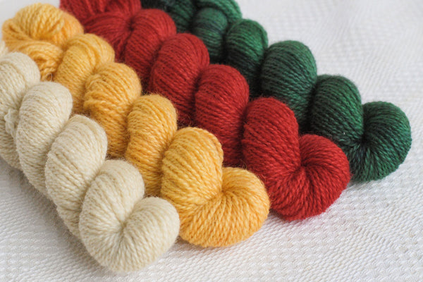 Set of 4 mini-skeins: natural (cream), yellow, bright red, and green