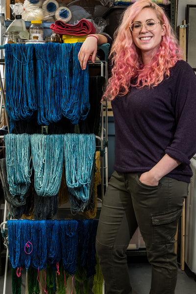 Sarah with dyed yarn hanging to dry