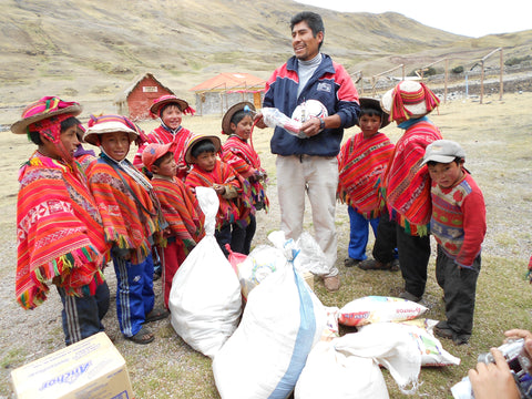 Teacher and Children in Chaullacocha receive the balls, along with their montly food supplement from the Reach Out Children's foundation.