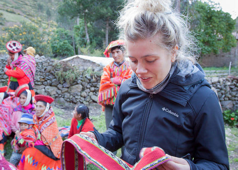 Checking out the impressive quality of their handwoven textiles.