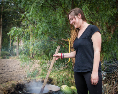 Alexa stirring a pot of cochineal for various shades of red, purple, pink and gray