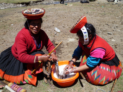 Paulina and friend wash their weavings - an important step in preparing the weavings for market.