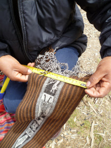 Daniel checks that the width of a scarf meets specifications